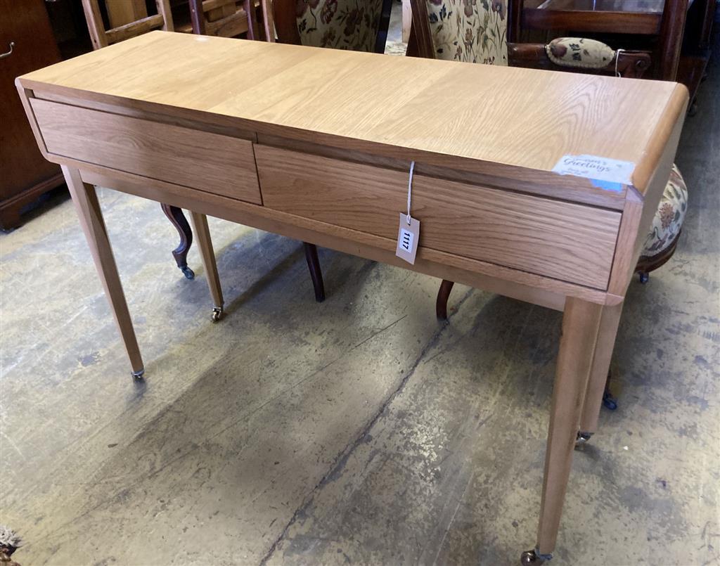 A contemporary oak two drawer side table, width 110cm, depth 35cm, height 79cm